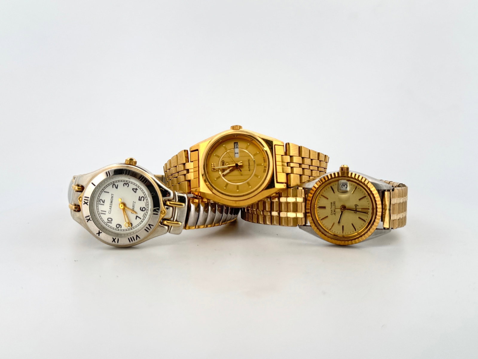 Three Ladies' Wristwatches: Claremont, Seiko, and Chatham: A collection of three ladies' wristwatches. The first is a Claremont quartz watch with a two-tone silver and gold-tone band, white dial, and Roman numeral markers. The second is a gold-tone Seiko 