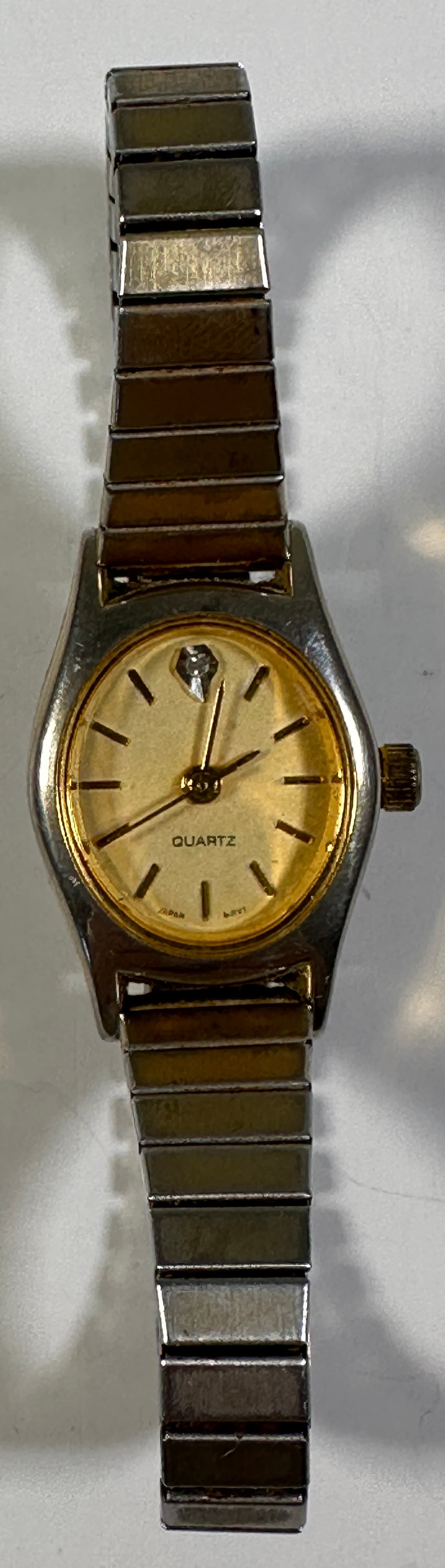 Ladies' Quartz Fashion Watch: Ladies' fashion watch with a gold-tone dial and silver-tone band. Quartz movement. Shows some wear. Weight: 0.8oz. Size: 3''. 