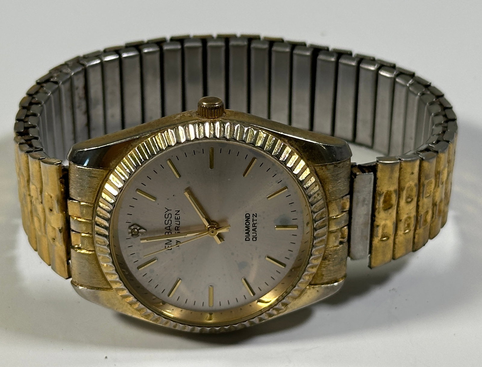 Embassy by Gruen Diamond Quartz Wristwatch: Embassy by Gruen Diamond Quartz wristwatch with gold-tone and silver-tone band. Weight: 1.8oz. Size: 2'' x 2.75''. 