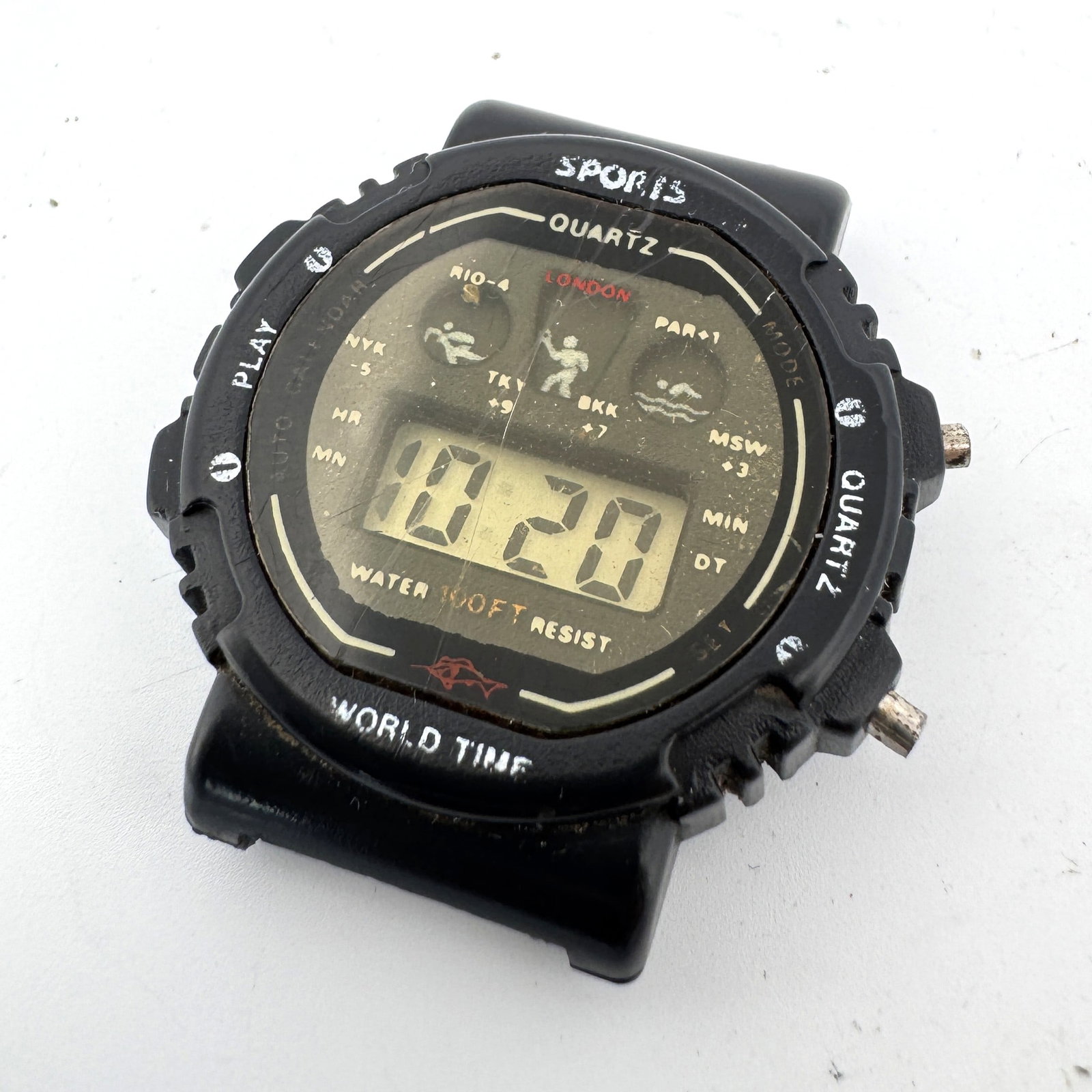 Sports Quartz World Time Digital Watch: Black Sports Quartz digital watch with world time function. Shows wear and age. Not tested for functionality. Weight: 0.3oz. Size: 1.25''.
