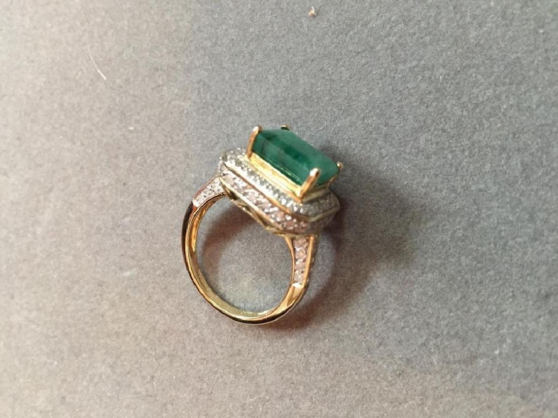 5.25ctw Emerald & Diamond 14kt Gold Ring: 5.25ctw, including a 4.65ct. emerald cut emerald focal stone, surrounded by diamonds, set into a 14kt white gold ring setting with a 14kt yellow gold gallery. Size 7.
