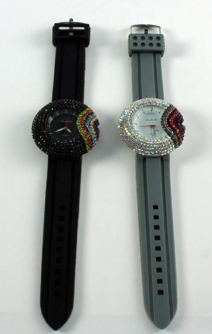 Pair Ladies Asian Rainbow Crystal Wristwatches: Colorful Rhinestones in a Rainbow Design surround the faces of both Asian brand watches. Analog display & Quartz movement. Silicon straps. Both watches were store displays, the black watch having some