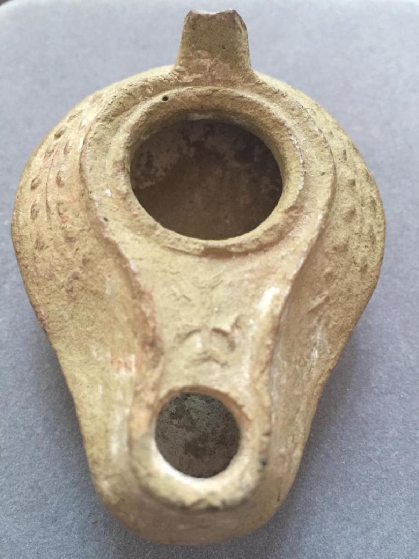 Ancient Byzantine, Syria & Palestine Clay Oil Lamp: 5th - 7thc AD Ancient Byzantine, Syria & Palestine, clay oil lamp. Buff to grey clay with a thin layer of encrustation. Spike handle & relief decoration of a vine on the shoulders, with a cross in rel