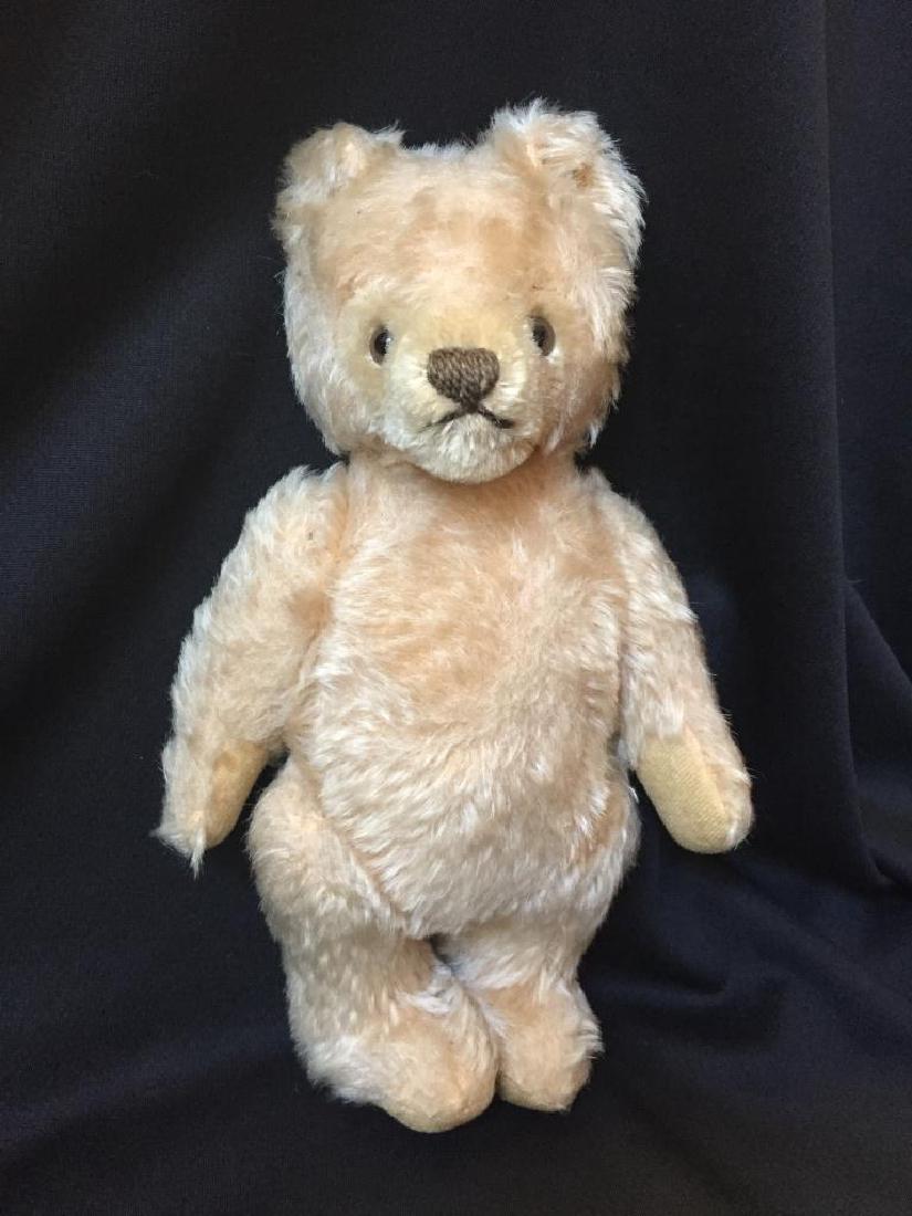 Mid Century Classic Steiff Articulated Teddy Bear: Mid 20th Century, German Steiff manufacturing company, blonde mohair, glass eyes, thread sewn nose & mouth, 10" articulated stuffed animal, classic teddy bear. Metal stud stamped Steiff in left ear. *
