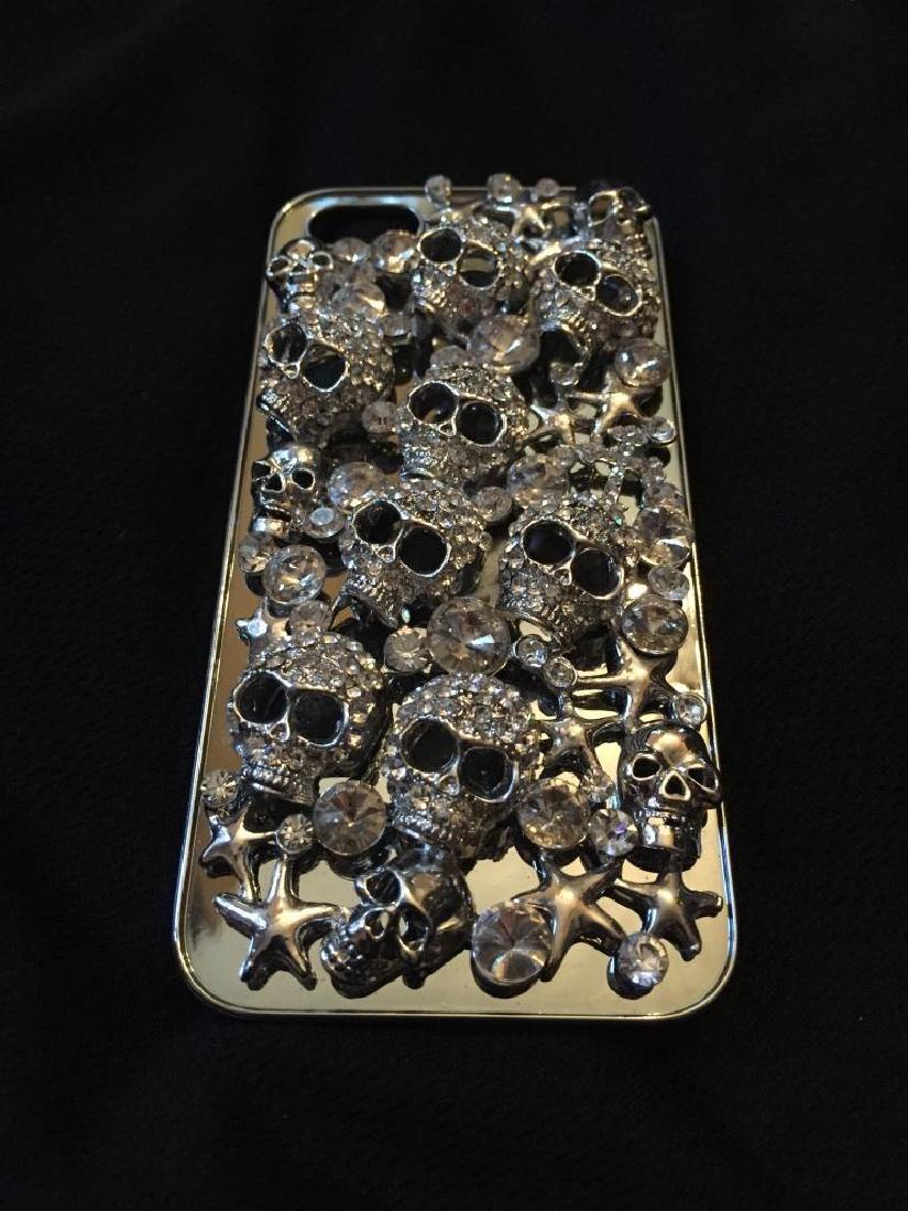 Austrian Crystal Skulls I-Phone Case: Austrian Crystal smart phone silver rhodium plated metal case, for the I-Phone 5/SE, decorated with Austria crystal encrusted multiple skulls. 5" X 2 1/4" X 7/8" D.