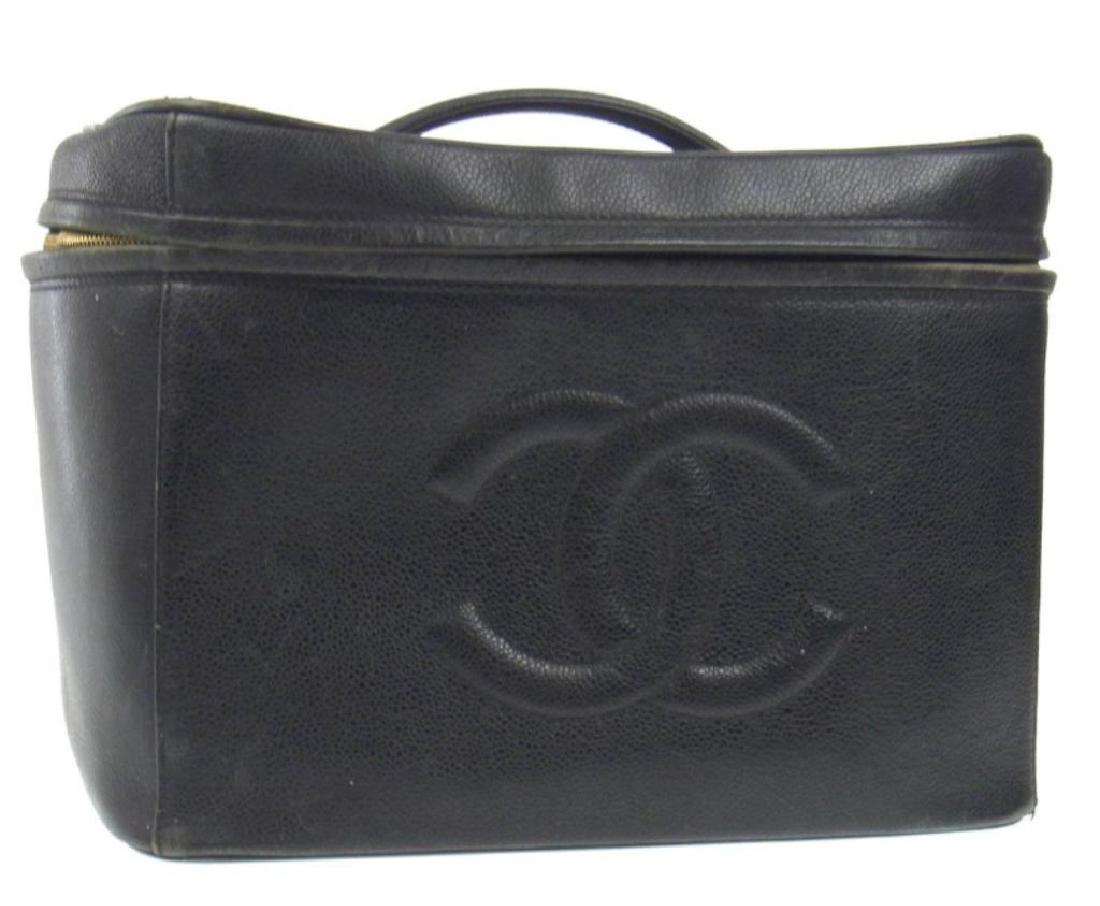 Large Vintage CHANEL Caviar Leather Train Case: Vintage & large, CHANEL black caviar skin leather cosmetic toiletry train case. 12" L X 8 " W X 8" H. Comes with original gold CHANEL marked lock. Four interior storage pockets & 3 interior straps for
