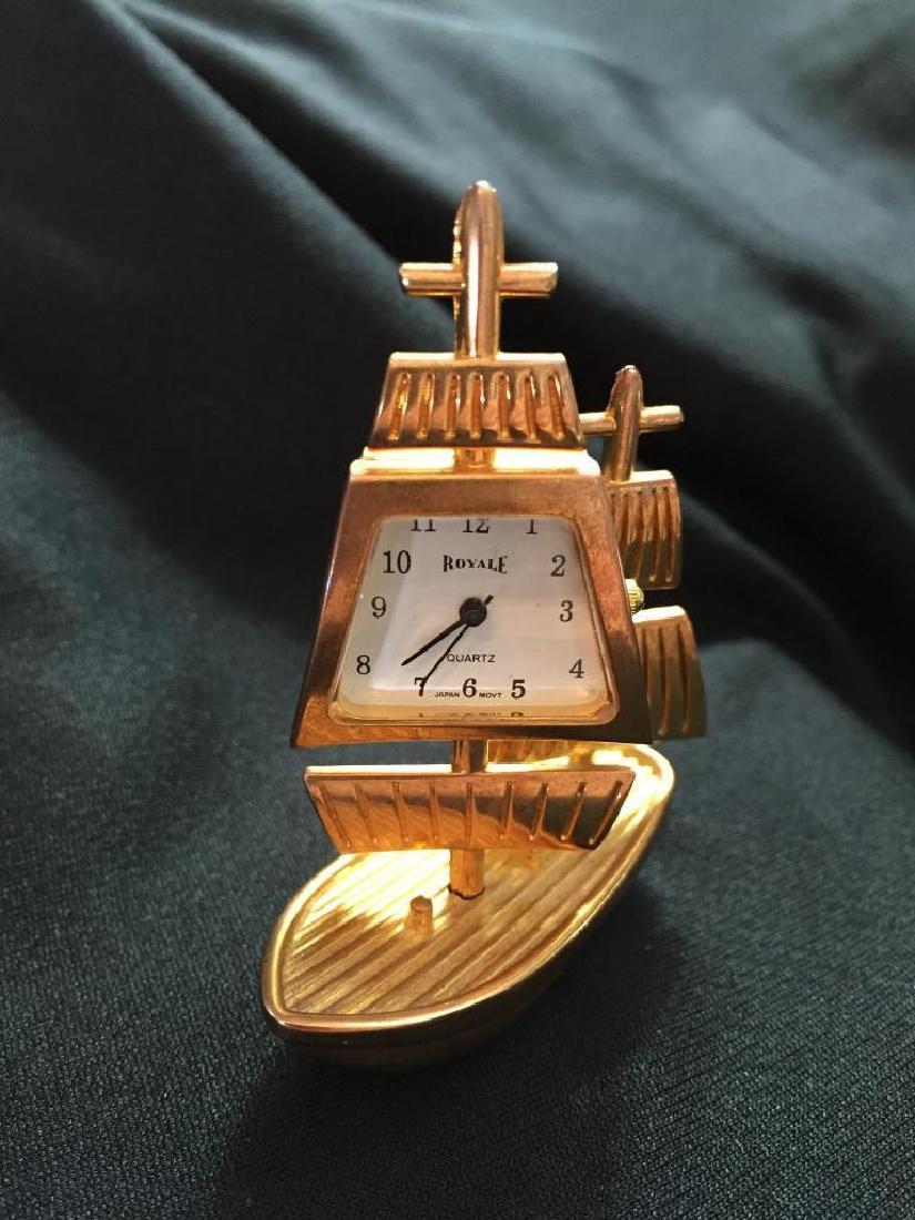 Miniature Brass Travel Clock, Sailing Ship: Miniature Royale collectible brass travel clock, in the form of a two-masted sailing vessel schooner. Japanese quartz movement. 2 1/2" H X 2" L X 1" W.