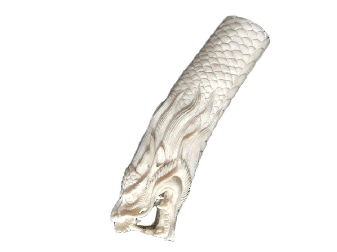 Hand-carved Antler Cane Handle, Snarling Dragon: Hand-carved shed deer antler, cane or walking stick handle, sculpture, in the form of a snarling dragon. Incredible detail on the body scales & fangs. 5 1/2" L X 1 1/2" W.