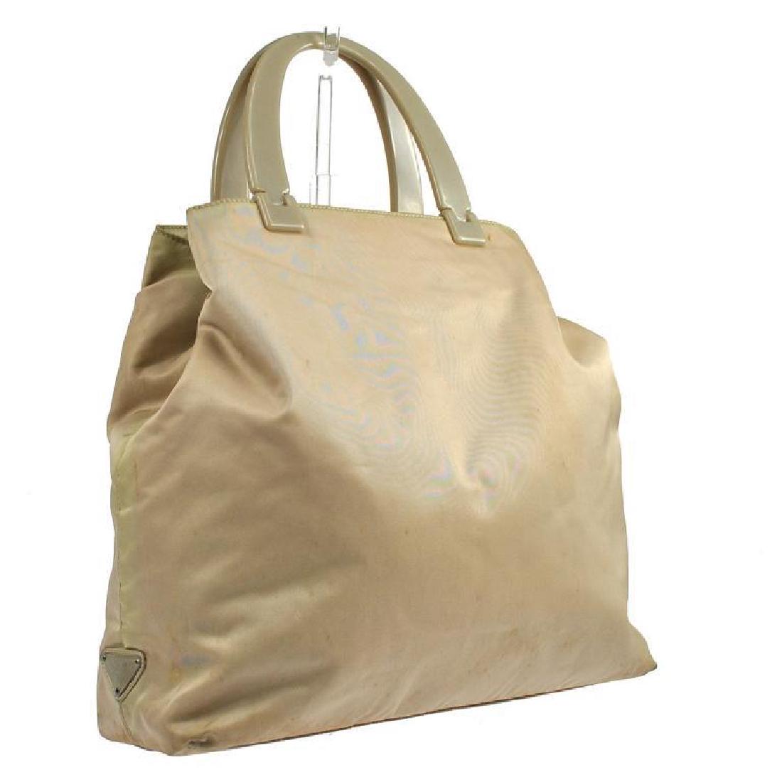 Authentic Prada Beige Nylon Lucite Handle Tote: Large, roomy interior measuring 12 1/2" H X 12" W X 3 1/2" D. "PRADA Milano metal tag on right side. Inside zippered pocket with metal "PRADA Milano', Made in Italy" tag. Lucite handles measure 5". Ne