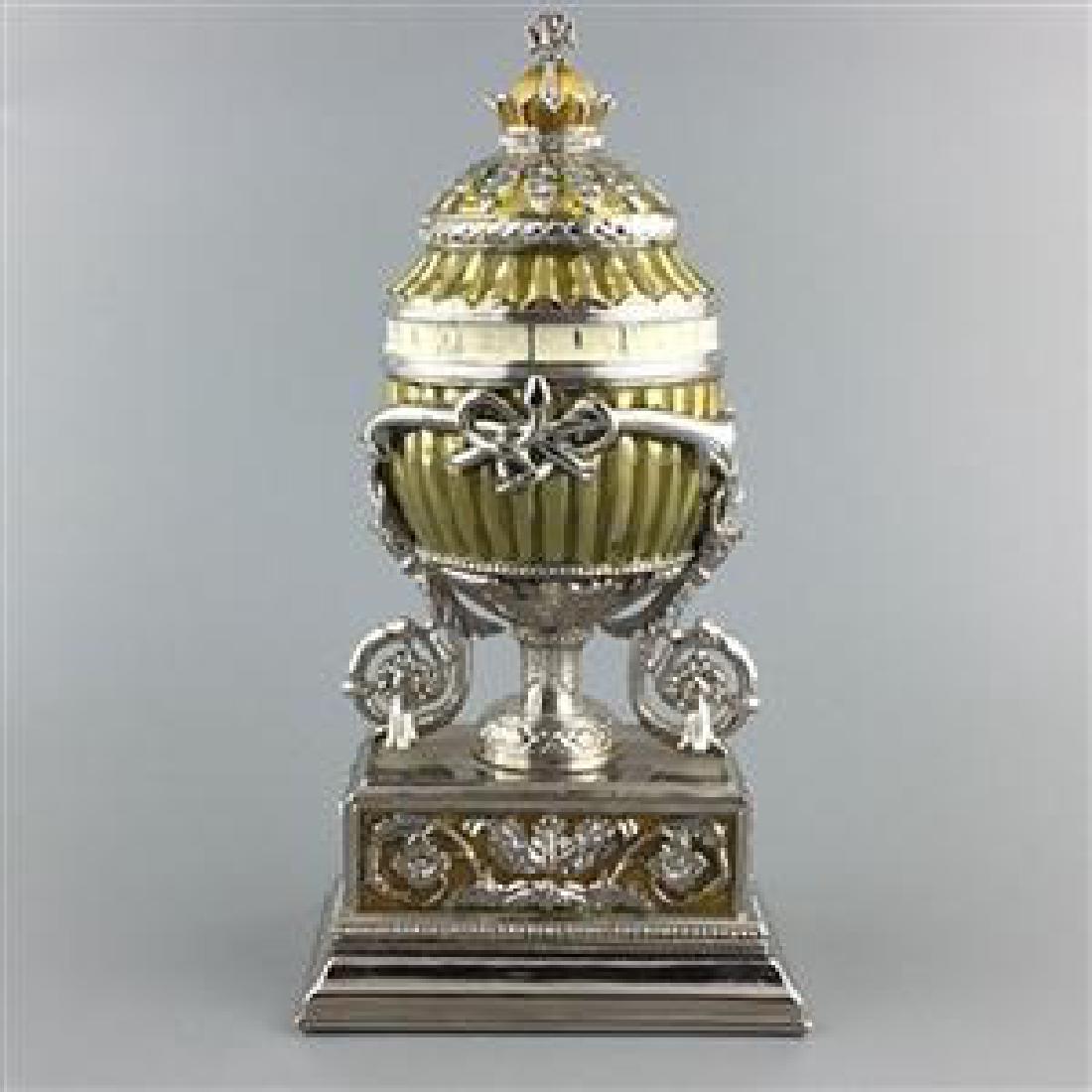Faberge Inspired " 1899 BOUQUET OF LILIES CLOCK: 1899 Bouquet of Lilies Clock Faberge Egg 6 '' (H) X 2.5'' (W) Enamel Gold Plated Pewter Hand Painted Gift BoxedThis hand painted sparkling egg is adorned with a high-polished enamel with golden trim. 