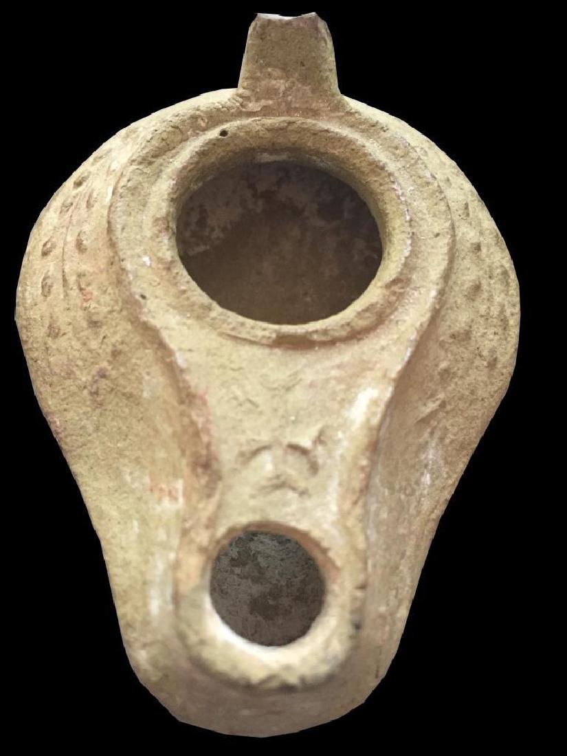 Ancient Byzantine, Syria & Palestine Clay Oil Lamp: 5th - 7thc AD Ancient Byzantine, Syria & Palestine, clay oil lamp. Buff to grey clay with a thin layer of encrustation. Spike handle & relief decoration of a vine on the shoulders, with a cross in rel