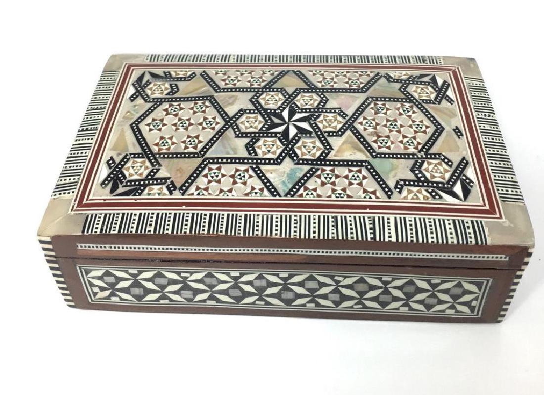 Egyptian Mother Of Pearl Inlaid Jewel Trinket Box: Egyptian walnut box, inlaid with tiny geometrically hand-cut pieces of natural mother of pearl abalone. Jewel or trinket treasure box. Red velvet lining. 8" X 5" X 2 1/2".