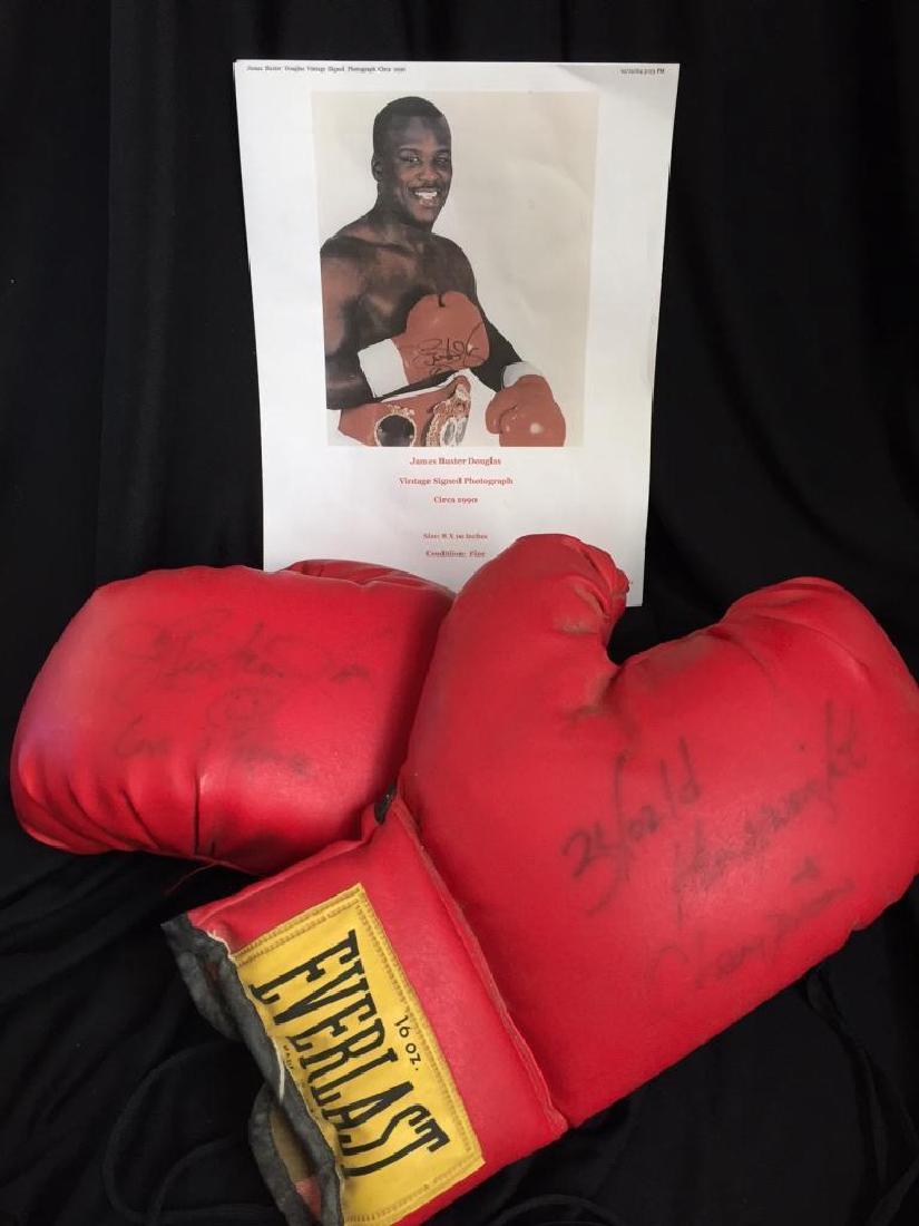 Authentic Buster Douglas Signed Boxing Gloves: Obtained in Las Vegas in the early 1990's, this pair of 16oz Everlast boxing gloves was signed by boxing legend Buster Douglas. The left glove has his signature with a smiley face below & the words "L