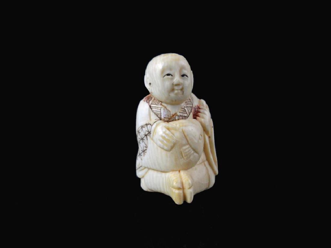Mid 19thc Hand-carved Netsuke Figure: Mid 1800's Japanese, hand-carved netsuke, in the form of a seated smiling man, holding a fish. Measures 1 1/2" H.Â 19th Century Meiji period ( 1868 - 1912 ) hand-carved sectional okimono figure of a