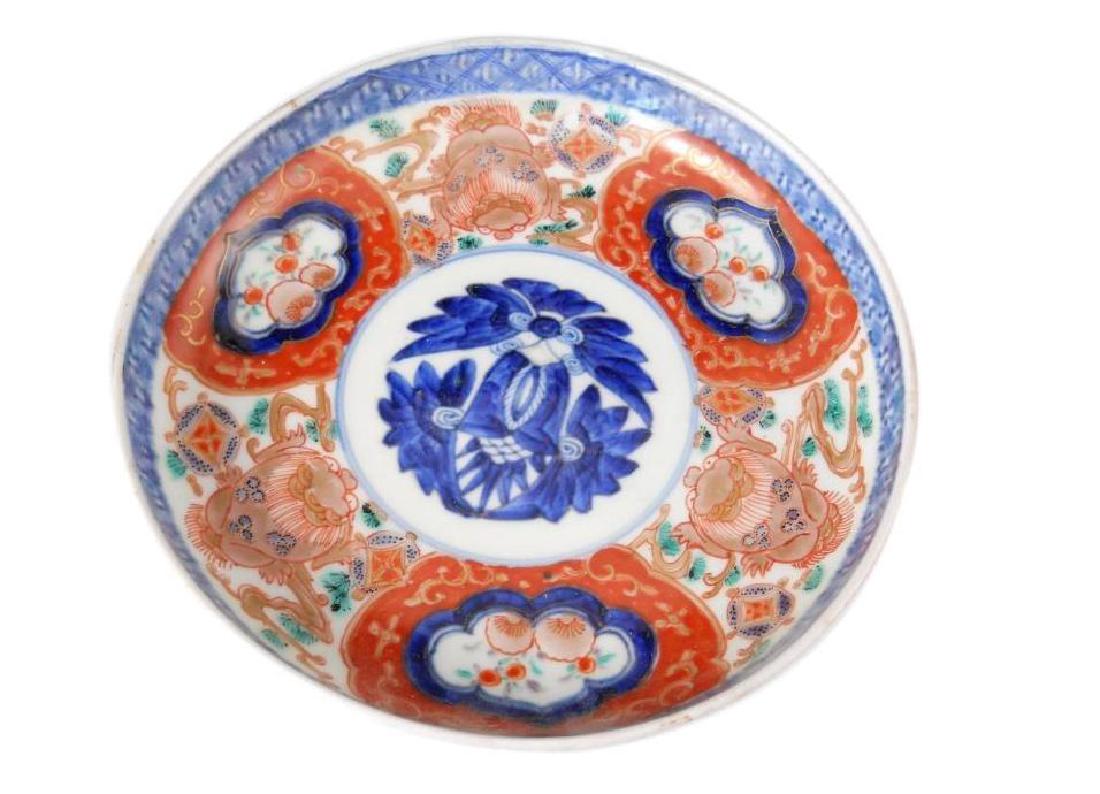 18thc Signed Japanese Imari Porcelain Saucer: Lovely antique Japanese saucer with floral & animal designs. Patterns in orange, blue, green & gold. Measures 6" X 6". Signed on the bottom.