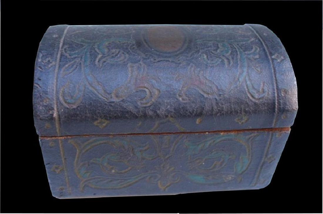 19thc Oilcloth Wooden Trinket Box: Antique, 19th century black wooden trinket box. The box ( 3 3/4" X 2 1/2" high ) is covered in oilcloth, with a tooled floral design. Nice cartouche on the top. The oil cloth acts as a hinge. Usual cr