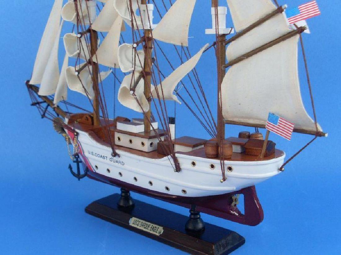 Wooden United States Coast Guard USCG Eagle Model Ship: Inspired by the USCG Eagle, one of only two active commissioned sailing ships operating in American military service, this adorable tall ship model cutter rests easily upon any shelf or desk. Add a to