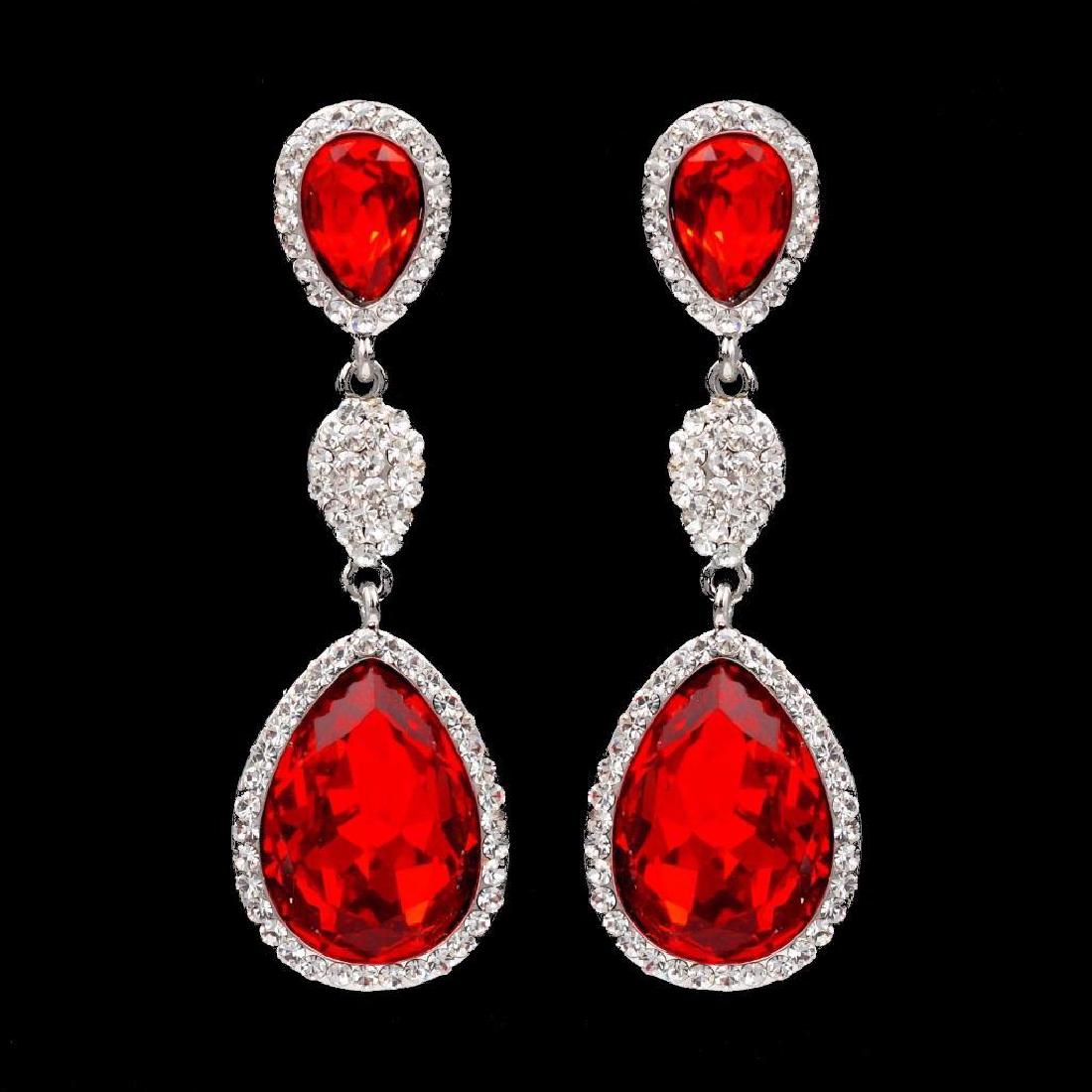 Rhodium Plated Red Crystal Rhinestone Chandelier Drop: Pierced earrings Stone / Color: Czech crystal / Red (Ruby) , Clear Metal / Color: Rhodium plated / Rhodium Length: 2.125" Weight: One earring is 0.21 oz Quantity: 1 pair