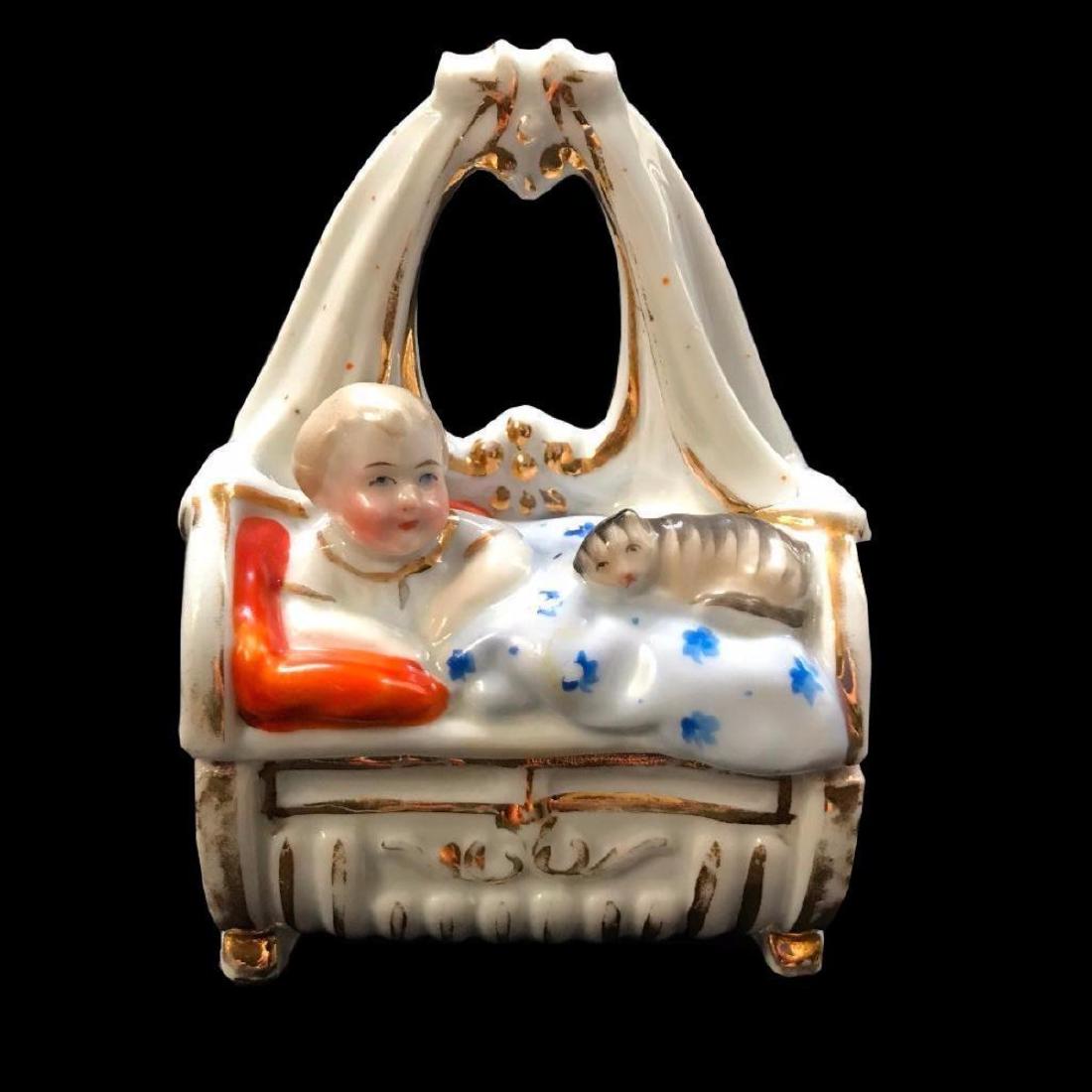 Late 19thc Victorian, German Conta Boheme,Child & Cat: Lovely late 19th Century, Victorian fairing box, German Conta Boehme porcelain, in the form of a child in bed with a cat. Shield & number stamp on bottom. Vivid colors & gold gilt remains. 4 3/4" H