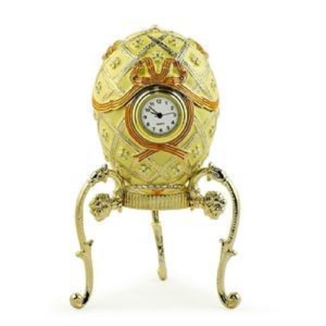 1916 Order of St. George Russian Faberge Egg: 1916 Order of St. George Russian Faberge Egg Beautiful strawberry red, green and golden enamel colors are intervened to produce this Royal Russian egg. The golden framed quartz clock at the center is 