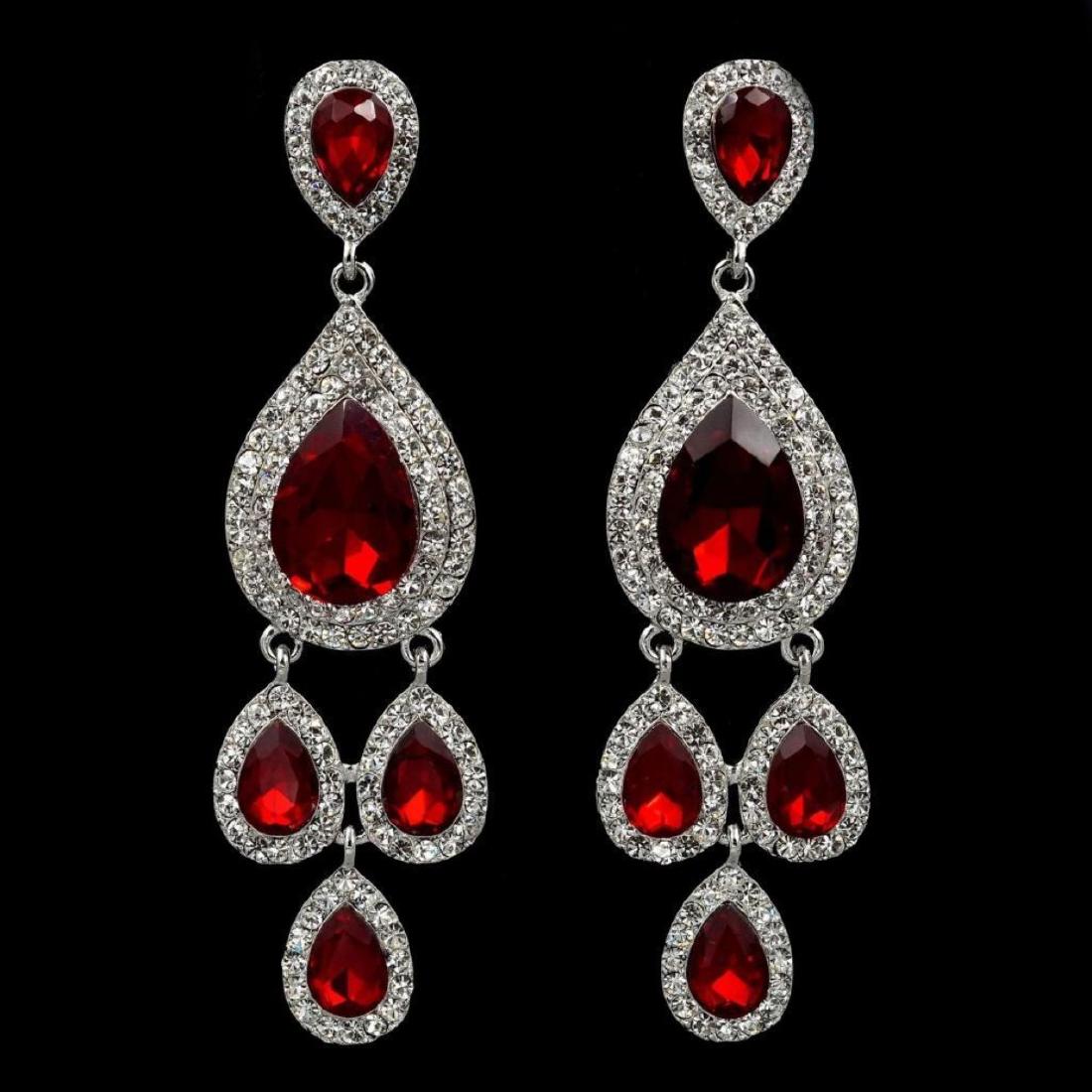 Rhodium Plated Red Crystal Rhinestone Chandelier Drop: Type: Pierced earrings. Stone / Color: Czech crystal / Red (Ruby), Clear. Metal / Color: Rhodium plated alloy / Silver. Length: 3.75". Weight: One earring is 0.39 oz. Quantity: 1 pair