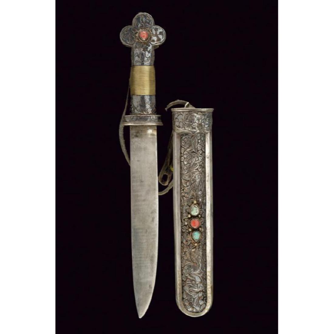 19thc. Ornate Tibetan Dagger: 19thc. Tibetan dagger withÂ wide straight blade with a thread. Supply covered with silver foil finely engraved with floral motifs, the clover-pommel with cabochon coral, the handle covered with bras