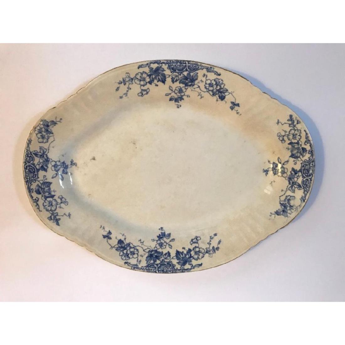 Large English Victorian Thomas Hughes & Son Flow Blue: LargeÂ English Victorian period flow blue semi-porcelain dinnerware platter. Thomas Hughes & Son elegant floral design, withÂ back-stamp to date this piece from 1895-1910. 17" L X 12" W.