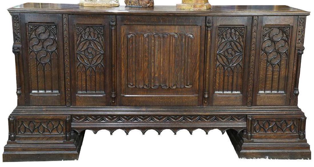 Gothic Revival Carved Quartersawn Oak Sideboard: Gothic Revival carved quartersawn oak sideboard, circa 1870, having a rectangular top, above the paneled case, central panel lifts and slides in, 46"h x 88"w x 21.5"d - 10273-042718-LA-02089