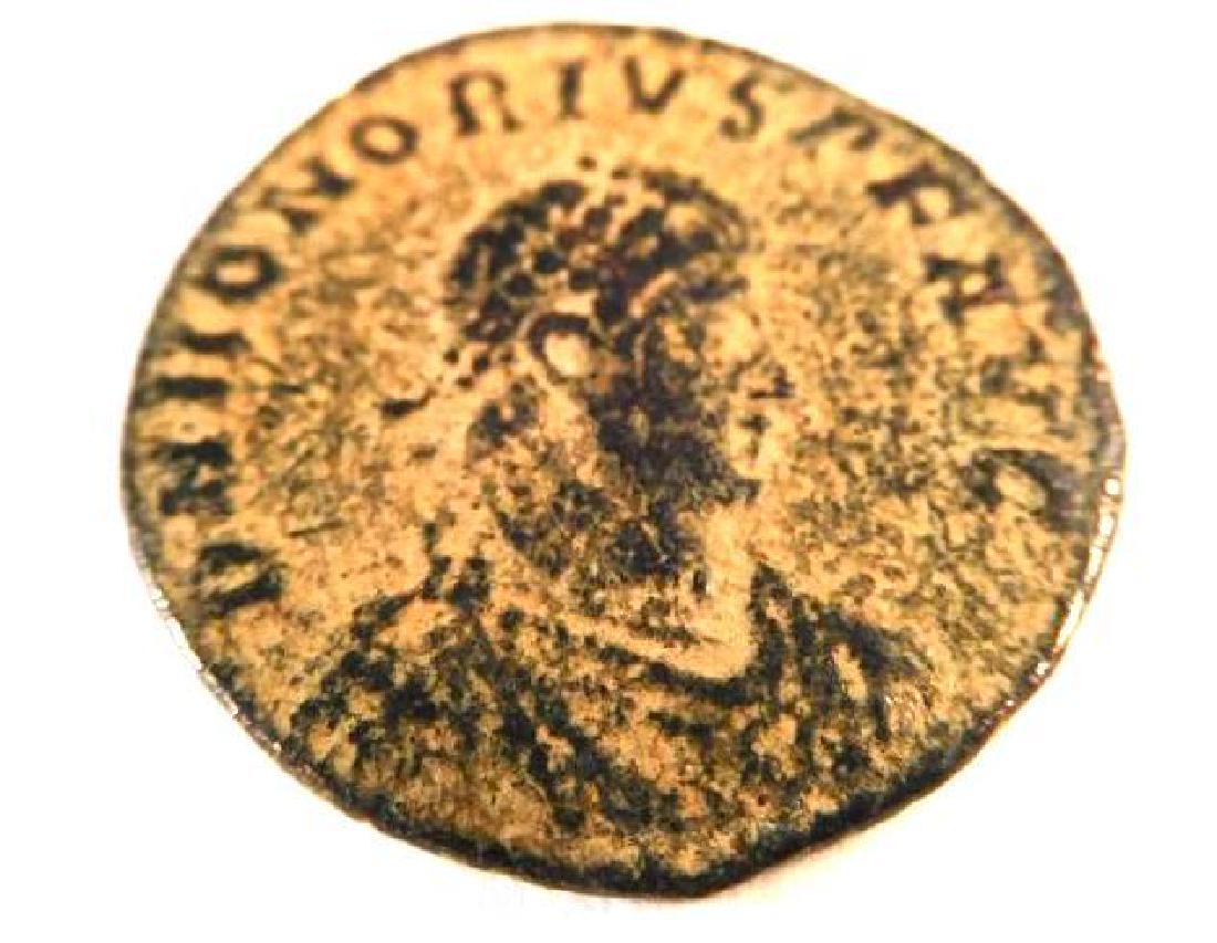 Bronze Coin of Honorius (393-423 A.D.): The reverse depicts the emperor standing, and reads GLORIA ROMANORVM "the glory of Rome". Honorius was born on September 9, 384 A.D., the younger brother of Arcadius, and son of Theodosius I. Unlike A