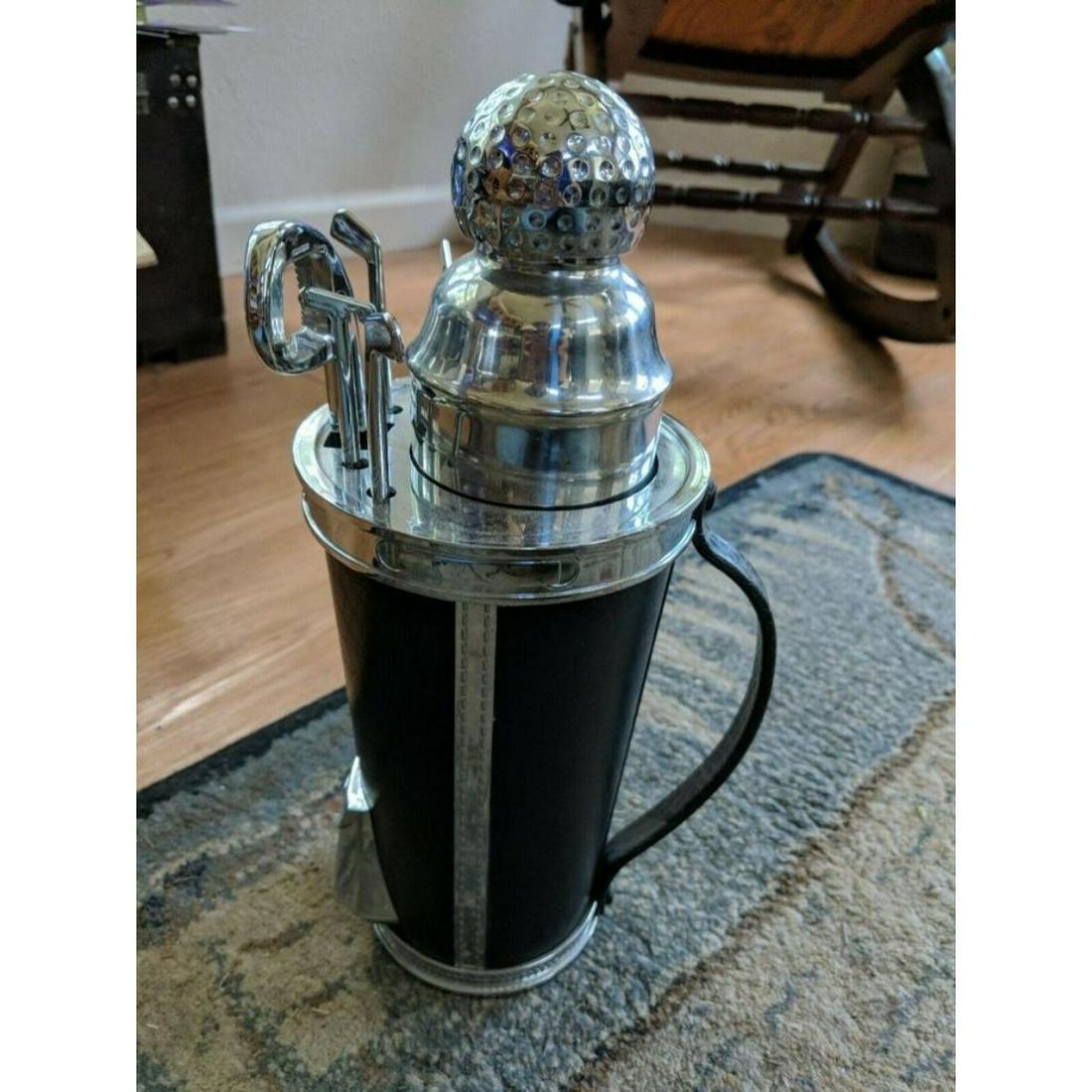 Novelty Golf Ball & Bag Cocktail Shaker Bar Set: Novelty cocktail shaker bar set, golfing theme with golf ball, bag & clubs. Golf ball capped shaker that removes from the bag base. Club shaped corkscrew & bottle opener & club stir sticks. 12" H X 4 