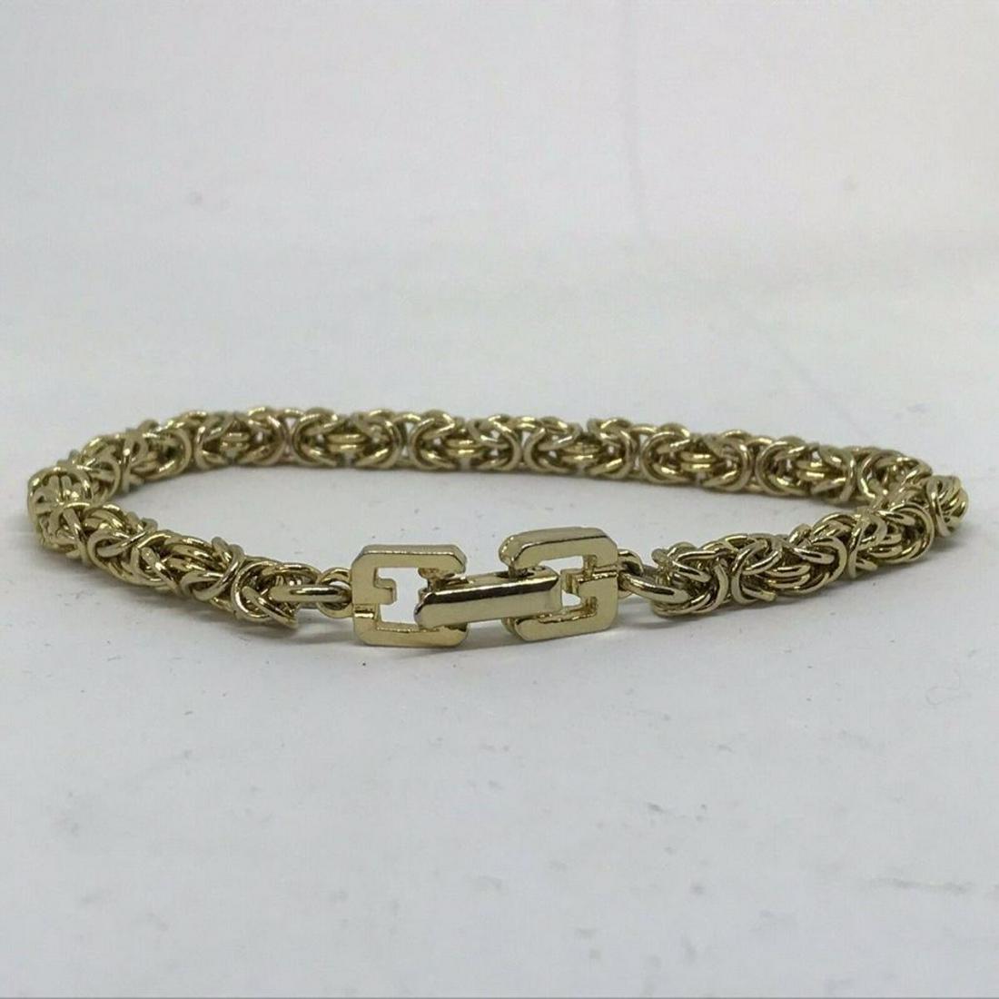 Vintage French GIVENCHY Gold Tennis Bracelet: Vintage French designer tennis bracelet, GIVENCHY, gold tone metal, double "G" clasp, GIVENCHY embossed on one clasp, 3/8" thick chain.