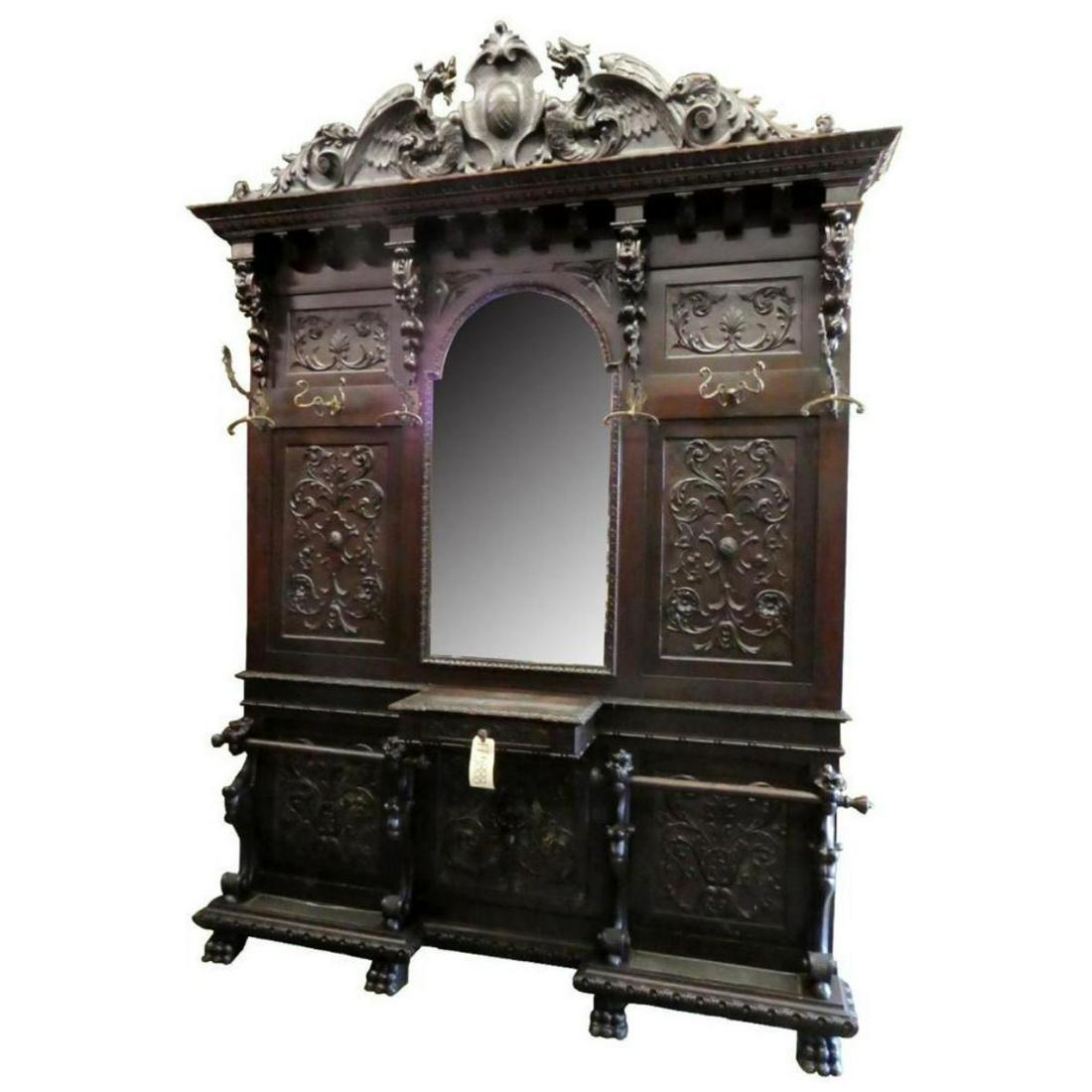 Late 19thc Carved Walnut Italian Renaissance Halltree: Italian Renaissance hall tree in carved walnut, with winged griffins flanking a cabochon crest, paw feet & center mirror. Late 19th century. 112" H, 84" W, 14.5" D. 10223-040718-LA-00124