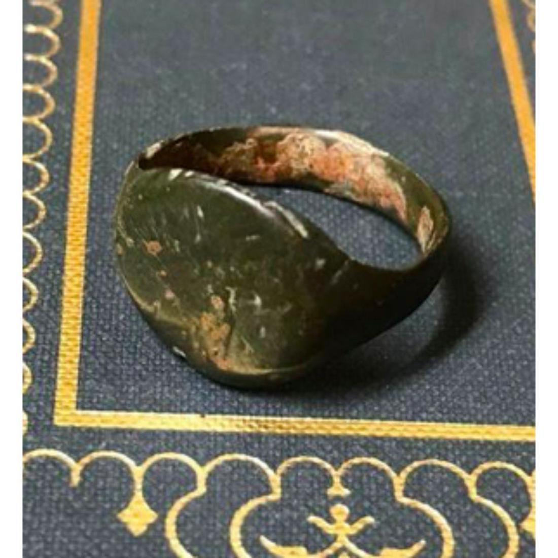 10th - 13thc AD Medieval Bronze Ring Artifact: 10th - 13th Century A.D.Â Northern Europe ( Germanic ). Bronze, originally gold plated, with oval bezel inscribed with very faint scrolling geometry. Bright patina from interaction with the gold. Ni