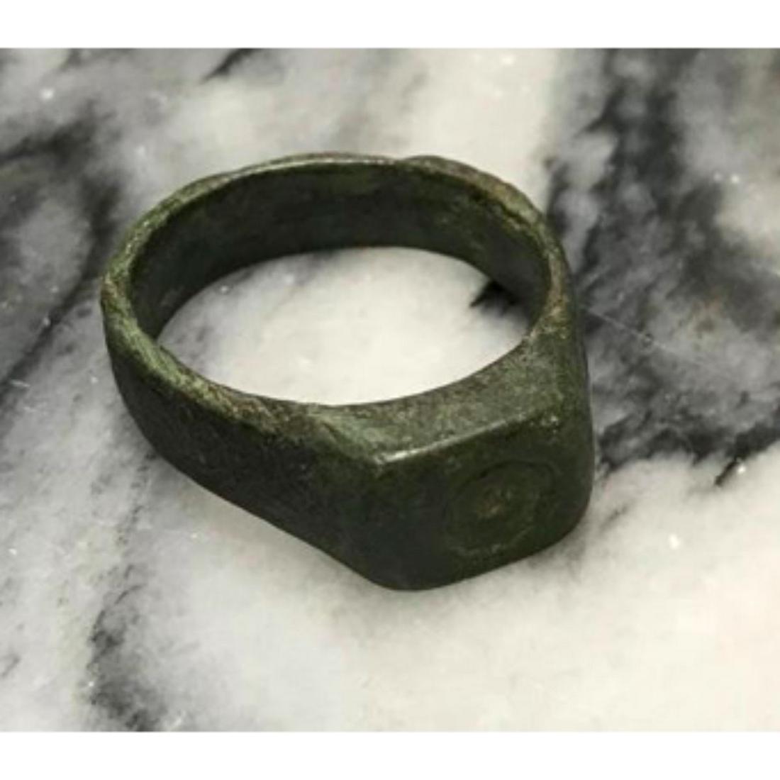 Late Roman Bronze Ring Artifact: Late Roman Period bronze ring, artifact, with squared bezel with an indentation for stone & vertical grooves along the band. Missing stone, possibly an intaglio glass stone? Wearable size 7.5. * sligh