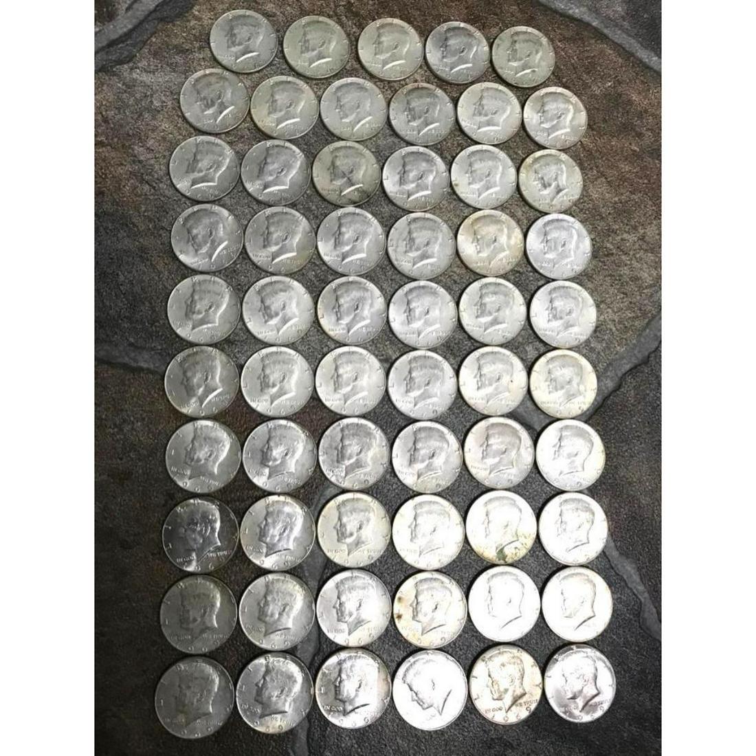 Collection of Silver Coins, 1969 Kennedy Half Dollars: Group of 59 Kennedy half dollars, all coins dating 1969, in various conditions, as pictured. From a home vault in Mississippi that was filled with 1960's era saved coins. Obverse - John F. Kennedy, 35