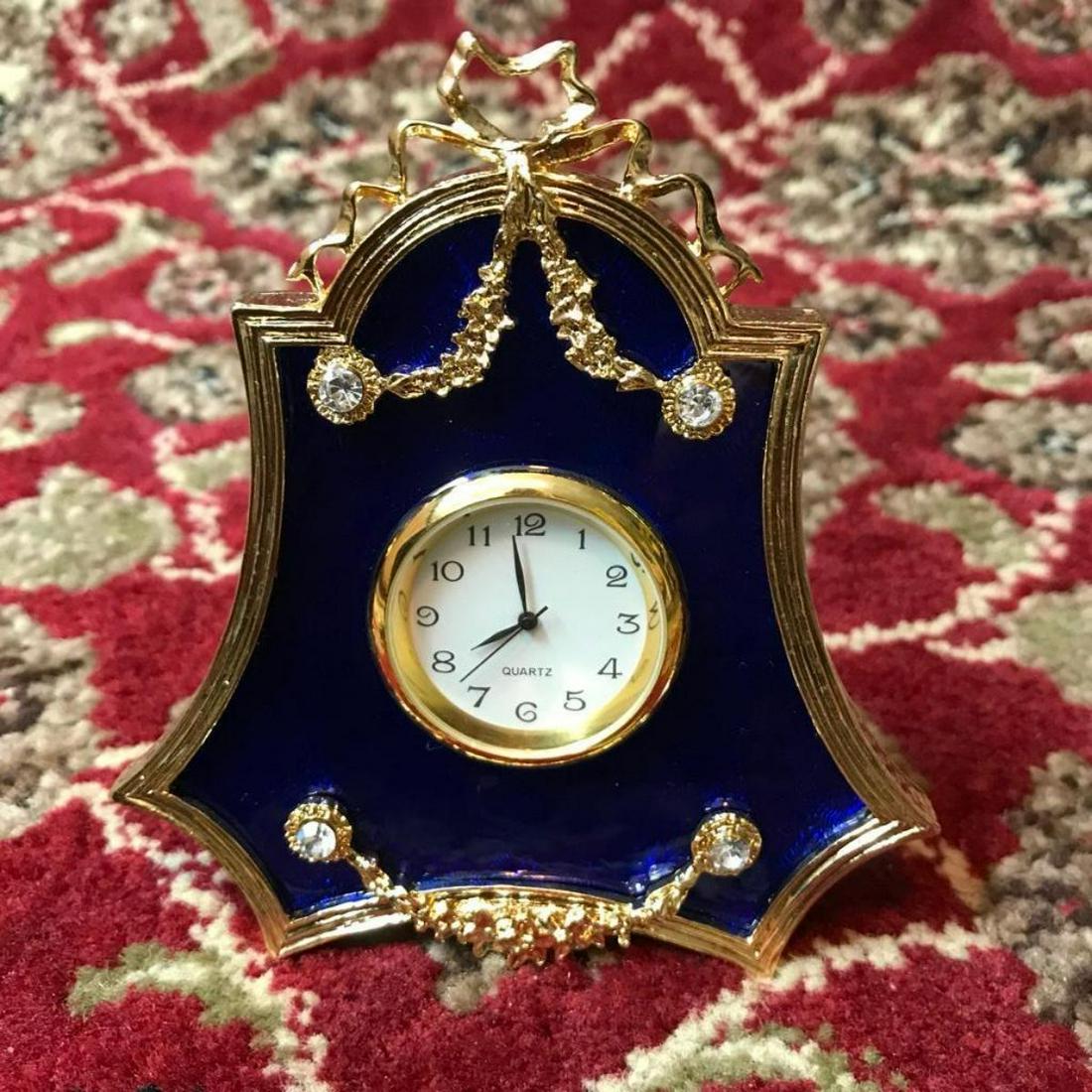 Russian Royal Faberge-style Guilloche Enamel & Gilt: Russian Faberge-style Royal Blue clock. Royal blue guilloche enamel & gold gilt over pewter with inset Austrian crystals & small quartz battery clock, standing frame backing. 4" H.Â