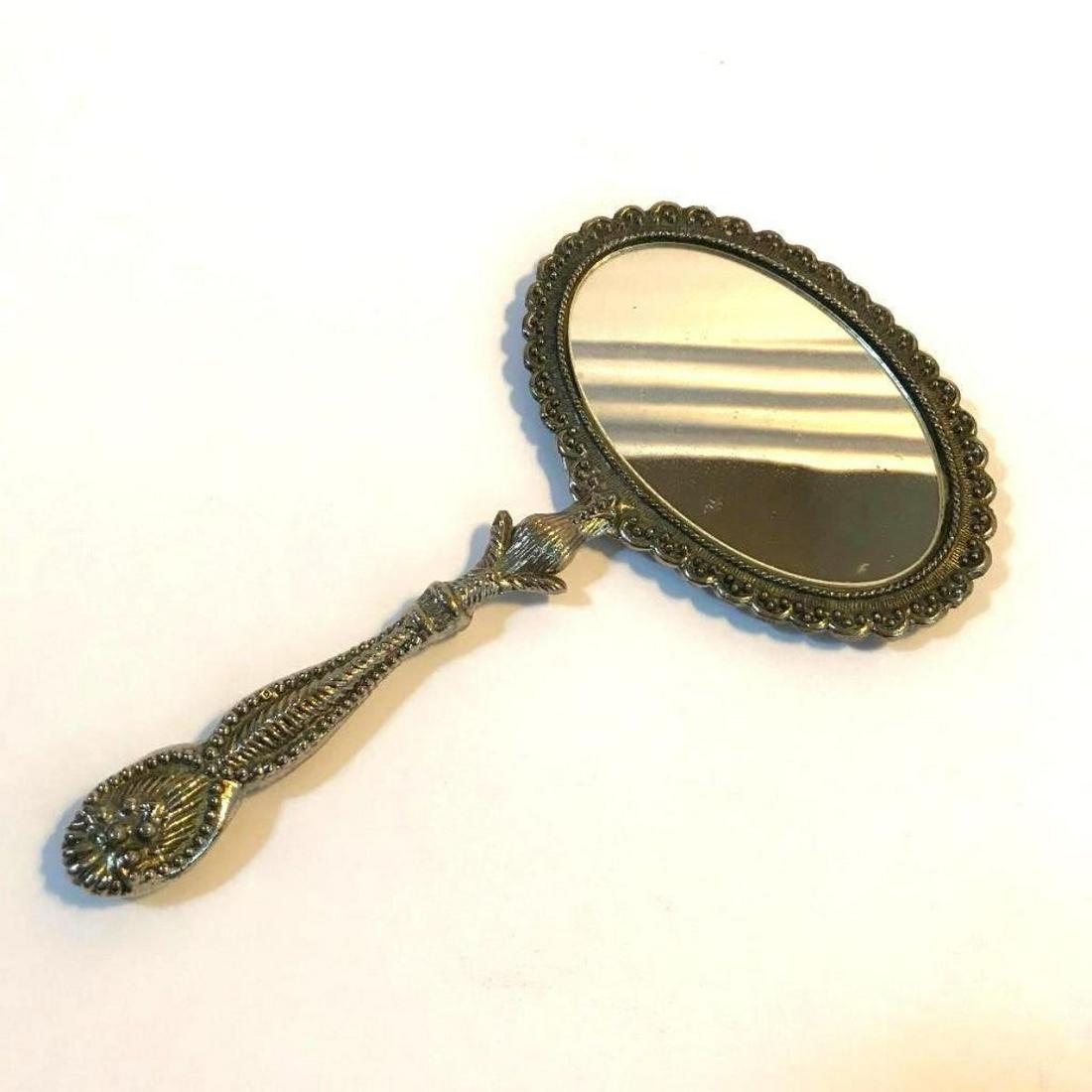 Vintage Ornate Silver Metal Dresser Hand Mirror: Vintage 1930's / 1940's wide oval, silver metal, cosmetic dresser hand mirror. 9 1/4" X 5 1/2". * slight loss to silver mirror backing along the edges of one side.