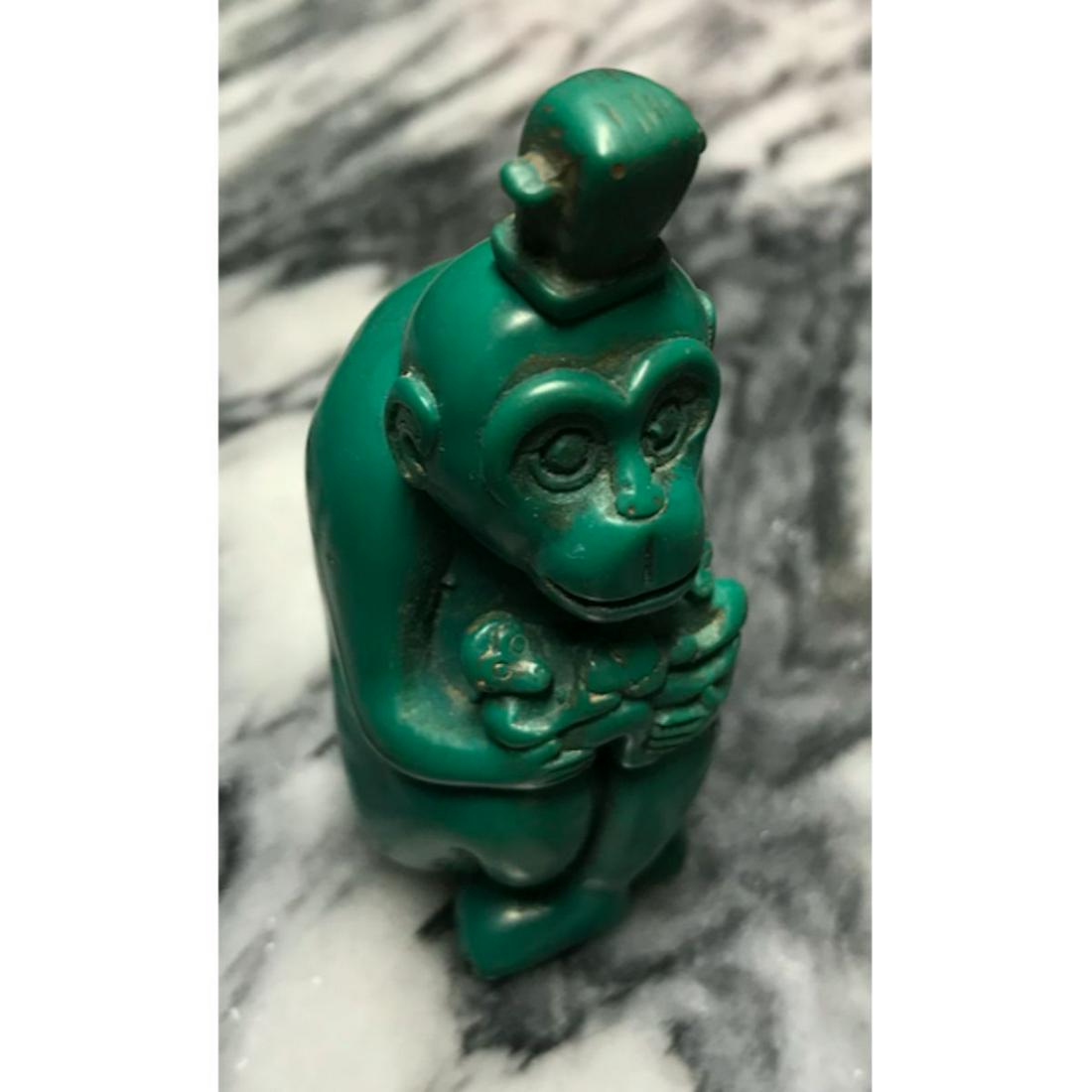 Vintage Chinese Monkey Snuff, Medicine Bottle: Vintage Chinese collectible snuff, medicine bottle, in the form of a monkey holding smaller monkeys. Carved out of "Block Turquoise" composite material. 3 1/2" H X 1 1/4" W.