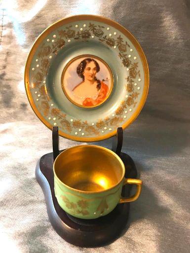 Sevres Style Porcelain Demitasse Cup & Portrait Saucer: Sevres-style porcelain demitasse set with stand. Porcelain portrait saucer, robin's egg blue, with gilt, moriage stipple & signature. Together with green & gilt cup with floral pattern & moriage stipp