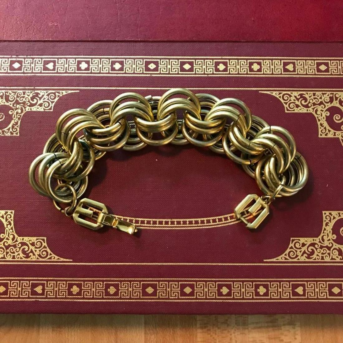 Vintage Designer GIVENCHY Gold Tone Woven Bracelet: Vintage designer bracelet, GIVENCHY, gold-tone metal large woven connecting circles with G clasp. Stamped GIVENCHY on the reverse side of clasp.