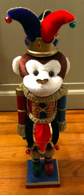 Monkey Jester Christmas Holiday Wooden Nutcracker: Christmas Nutcracker Decoration, in the form of a monkey wearing jester outfit. Painted wood with cloth & trim decoration. 16" H X 5" W. Stands on glitter over wood base.