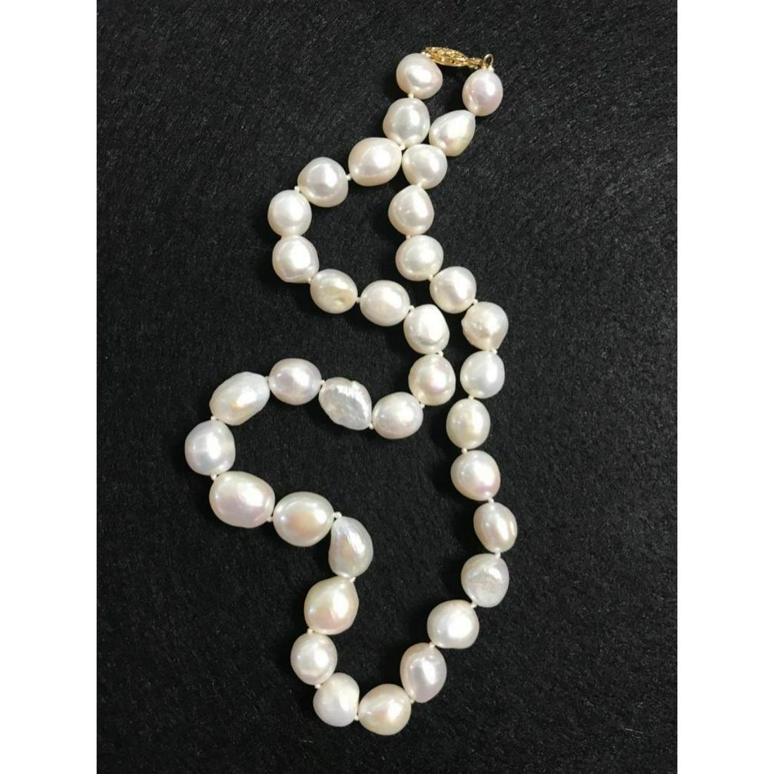 12-13mm White South Sea Baroque Pearl Necklace: 12-13mm white South Sea Baroque pearls 19" necklace with 14kt yellow gold clasp.