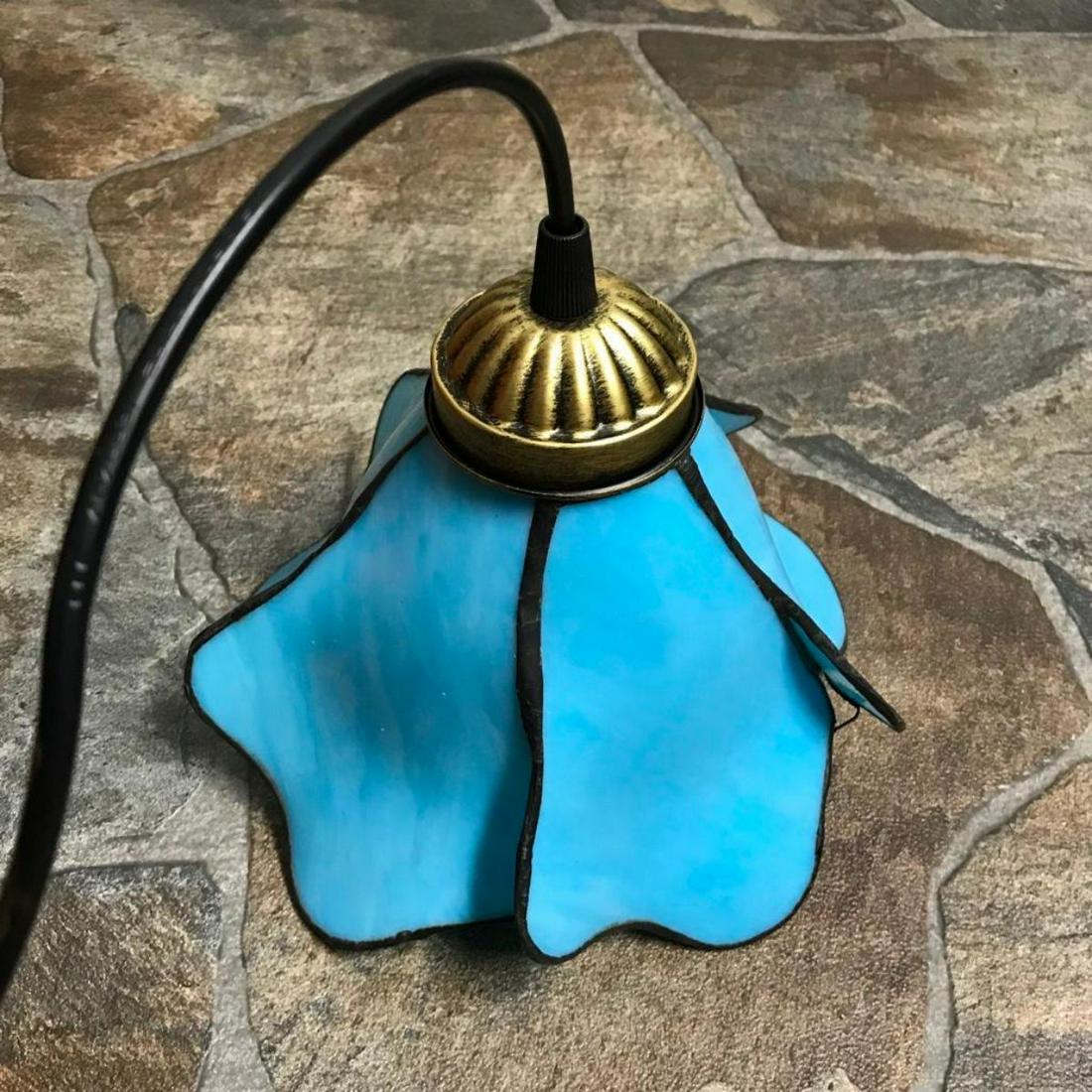 Blue Glass Flower Hanging Plug-In, Convertible Pendant: Light blue art glass flower hanging pendant light. Comes with convertible plug-in cord for hanging as a temporary fixture, as well as hardware for hanging as a permanent ceiling fixture. 8" W sha