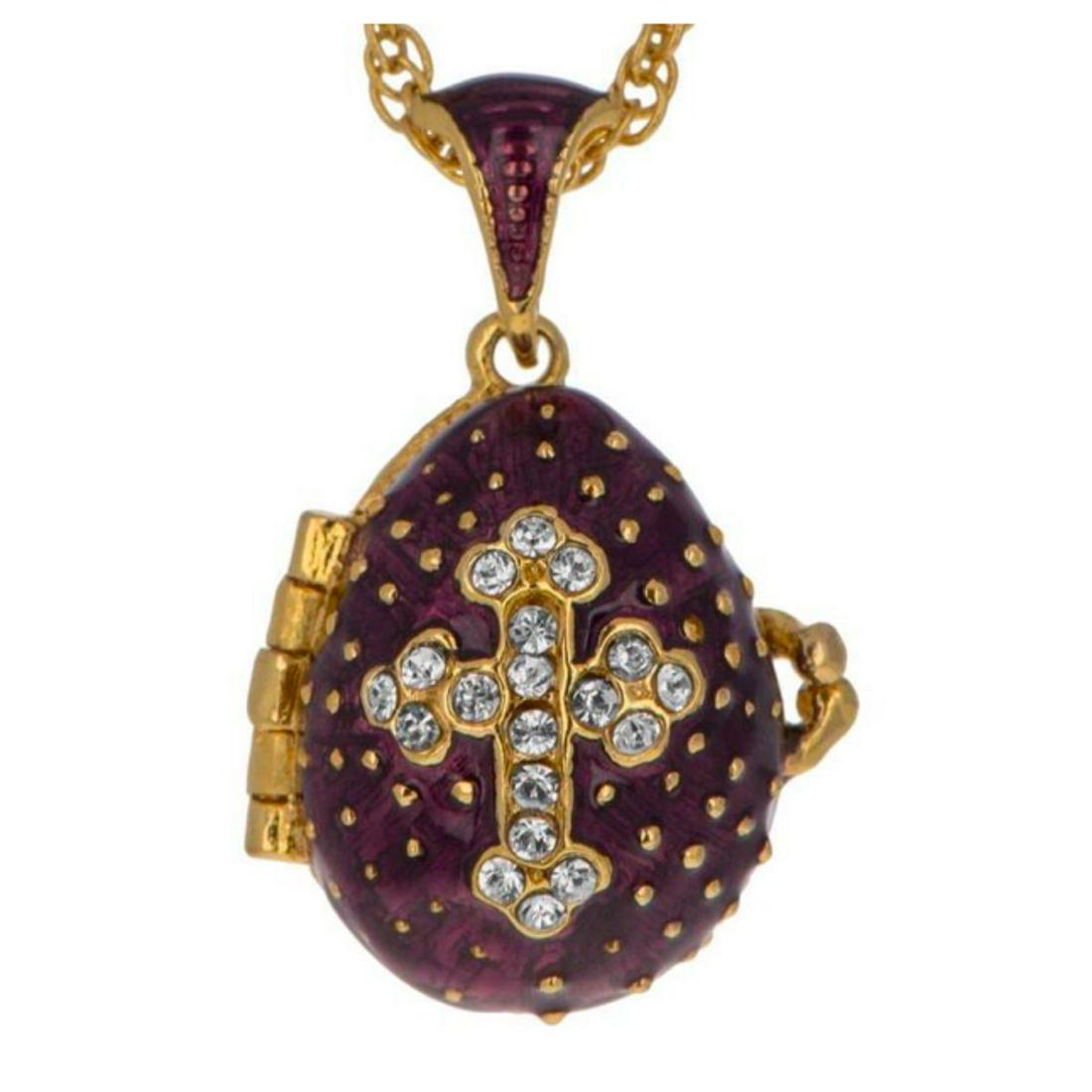 Purple Russian Cross Crystal Locket Egg, Pendant: Enamel & brass, with 19 embedded Swarovski crystals forming a cross design. The tiny purple egg opens to reveal an enameled interior with a tiny cross charm inside. Comes with 20" chain & gift box. 24