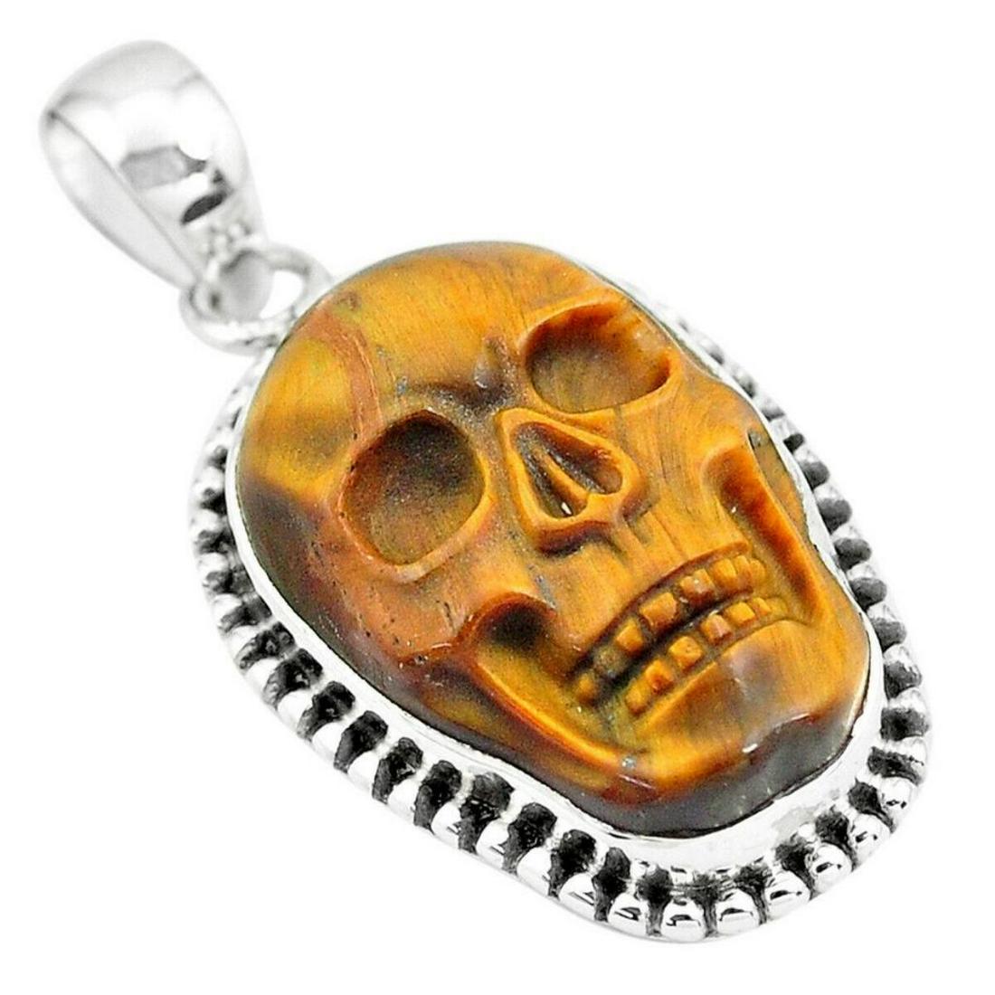 16.43cts Carved Tigers Eye Skull Sterling Silver: 16.43cts Tigers Eye Skull carving set into a stamped 925 sterling silver pendant. 1 3/8" L. 7.47 grams weight.