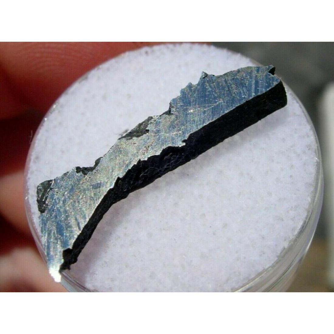 2.16 grams Saint-Aubin France Metrorite Fragment: 2.16 grams Saint-Aubin ( Iron, octahedrite ) Meteorite, cut fragment specimen from the masses found in Aube Champagne, France, 1968. Five masses of total weight 472 kg were found by farmers while plou