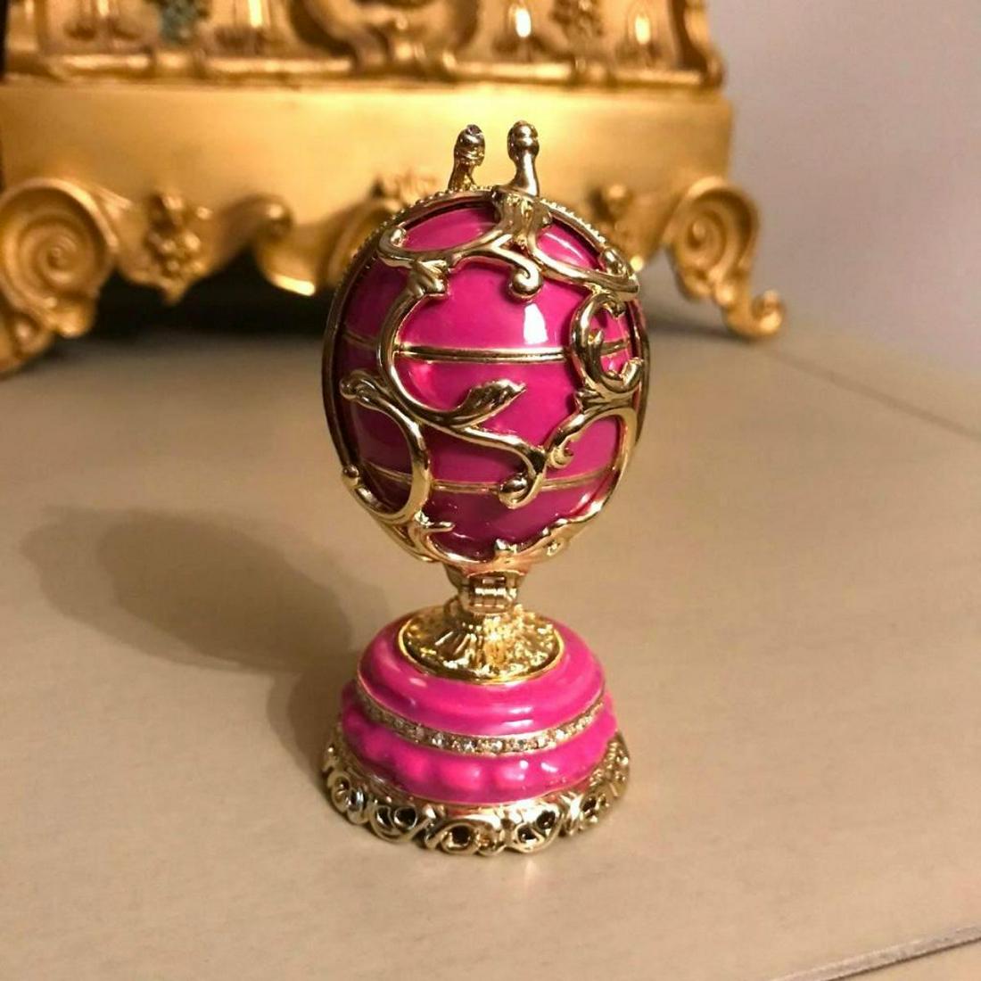 Spring Flowers Russian Faberge Inspired Egg: Russian Faberge inspired decorative egg, jewel, trinket box. Hand-painted enamel over pewter & gilt with embedded Austrian crystals in a Spring Flowers theme. The Egg splits in the center on a hinge t