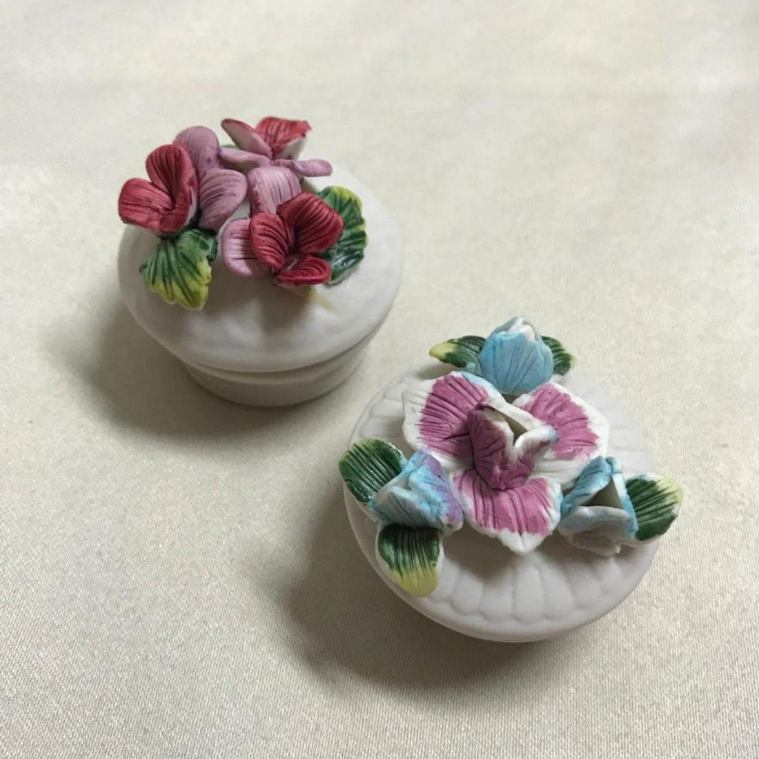 Pair of Bisque Porcelain Flower Trinket Boxes: Pair of hand-painted bisque porcelain hand-painted flower theme trinket boxes. 2" each.