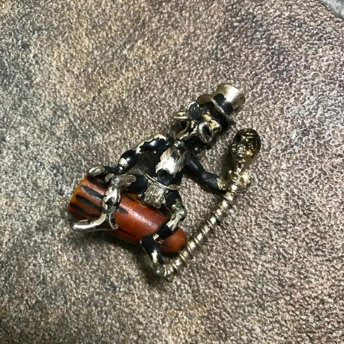 Rare Mid 20th Century Voodoo Man Bakelite Pendant: Rare Mid Century Charles F Worth African Tribal Witch Doctor, Voodoo Conjure man, wearing top hat & sitting on a congo drum, holding a skeleton staff, pendant. Enamel over metal with bakelite drum. *