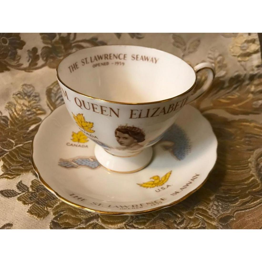 1959 Commemorative Queen Elizabeth Teacup: Tea cup & saucer commemorating the opening of The Saint Lawrence Seaway by H.M. Queen Elizabeth II, 1959. Images of the young queen on both cup & matching saucer, as well as a Canadian maple leaf & U.